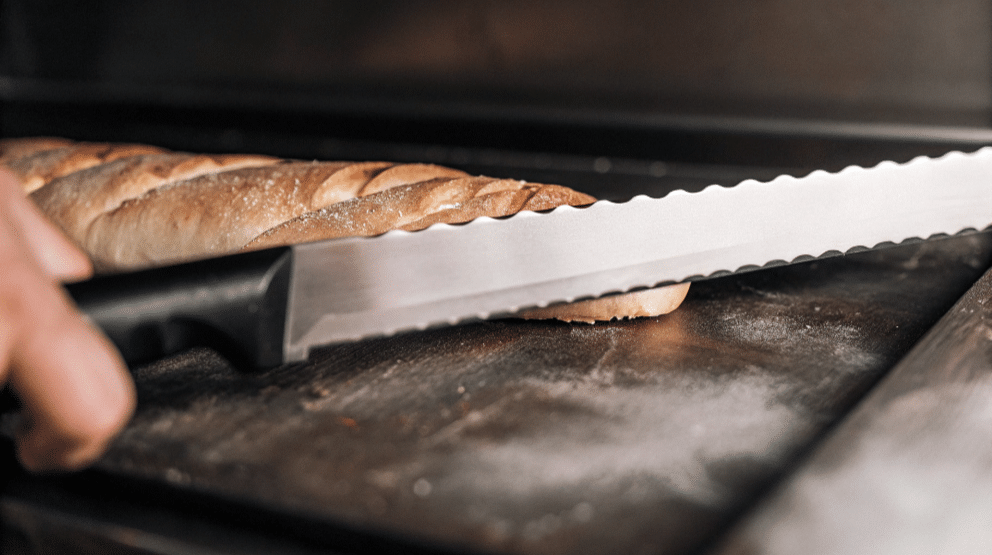 Choose a Japanese Bread Knife - Japanes Knives Tips The image features a beautifully crafted Japanese bread knife, showcasing its serrated blade designed for effortlessly slicing through soft sandwich bread and crusty loaves. The high carbon stainless steel construction ensures longevity and sharpness, making it a favorite among bakers for creating clean cuts and thin slices.