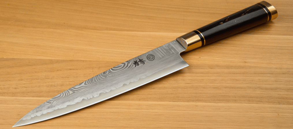 A closeup of a Honesuki Knife.