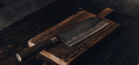 A photograph of a Japanese Cleaver on chopping board.