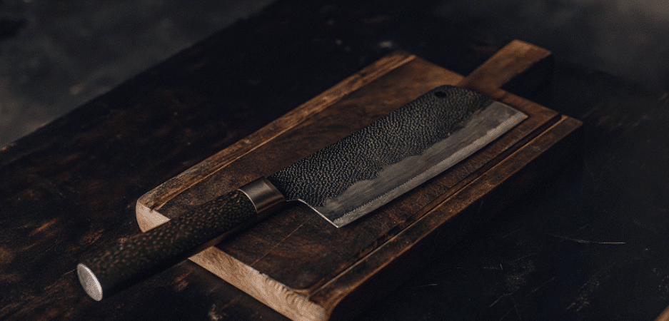 A photograph of a Japanese Cleaver on chopping board.