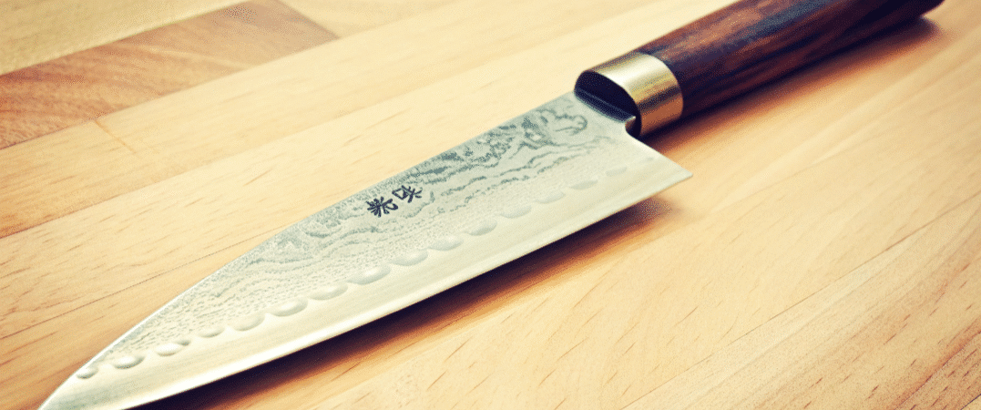 Japanese Knife Carbon Steel - Japanes Knives Tips A Japanese Knife on a wooden chopping board.