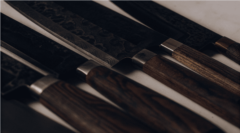 Knife Types - Japanes Knives Tips The image showcases a variety of Takamura knives, including chef's knives and santoku, highlighting their traditional Japanese craftsmanship and superior sharpness. Each knife is designed for professional chefs and culinary enthusiasts, featuring stainless steel blades that offer excellent edge retention and a perfectly balanced feel.