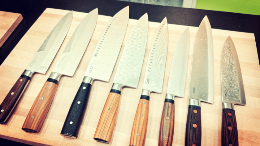 Various Gyuto Knives - Japanes Knives Tips The image depicts a selection of various gyuto knives, showcasing their pointed tips and sharp edges, designed for precision chopping, slicing, and dicing in the kitchen. Among the knives, you can see different types, including those made with Damascus steel and featuring a balanced design, ideal for both meat and vegetables.