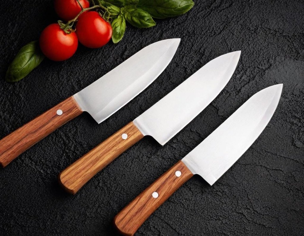 Three Japanese knives on a black background.