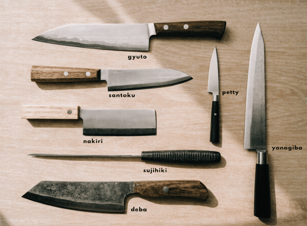 Several Japanese Knives - Japanes Knives Tips A top-down flat lay of several Japanese knives neatly arranged on a light wooden surface, including gyuto, santoku, petty, nakiri, sujihiki, yanagiba, and deba, each knife clearly visible, product photography, clean background, soft natural light